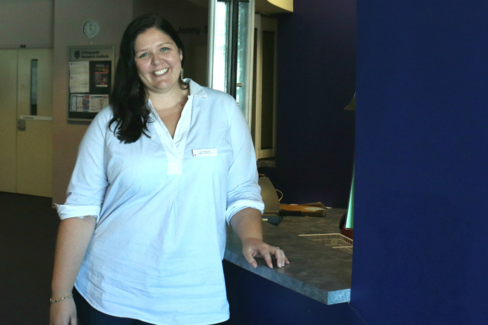 Nurse leaning on reception desk