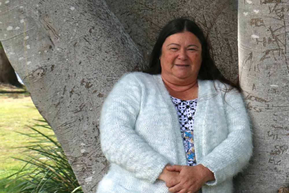 Woman leaning on tree