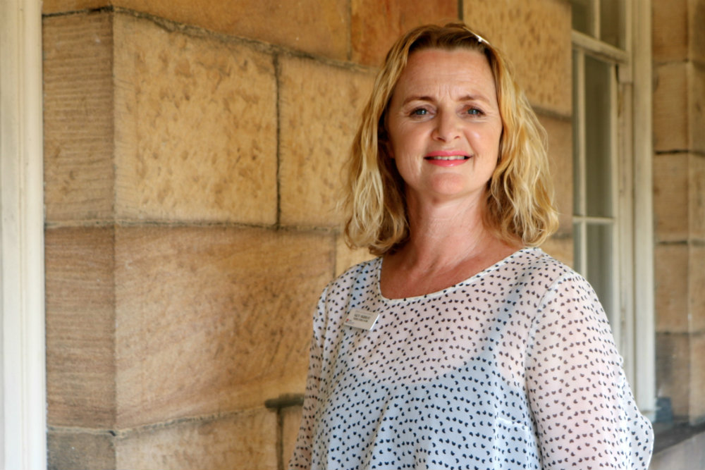 Lady in front of sandstone wall