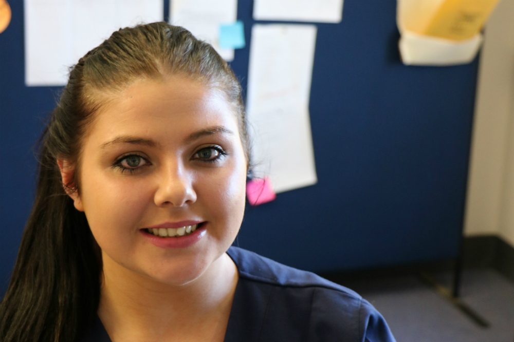 Nurse in front of bulletin board