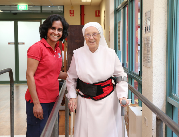 Photo of Physio helping older person to walk