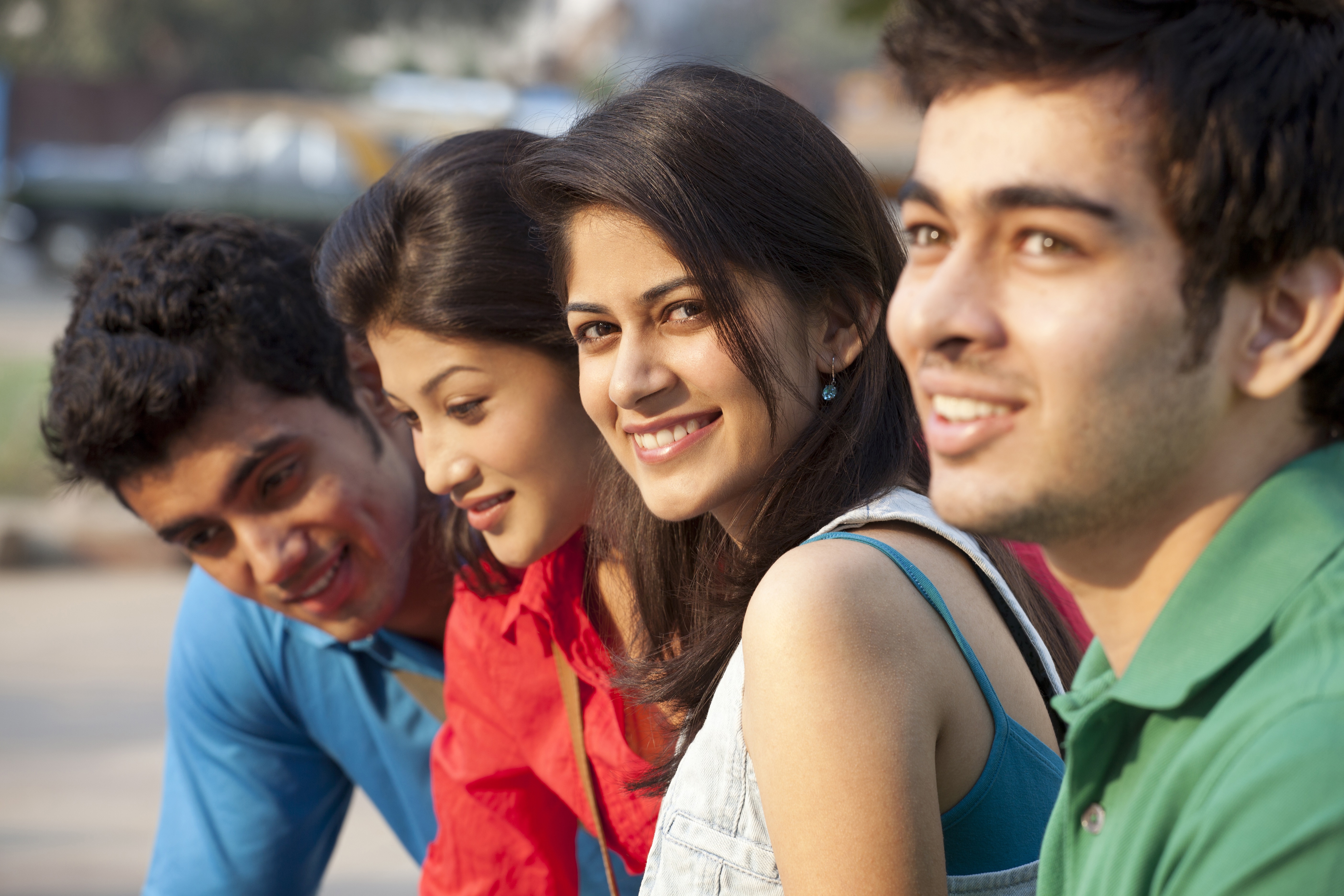 Four young smiling people