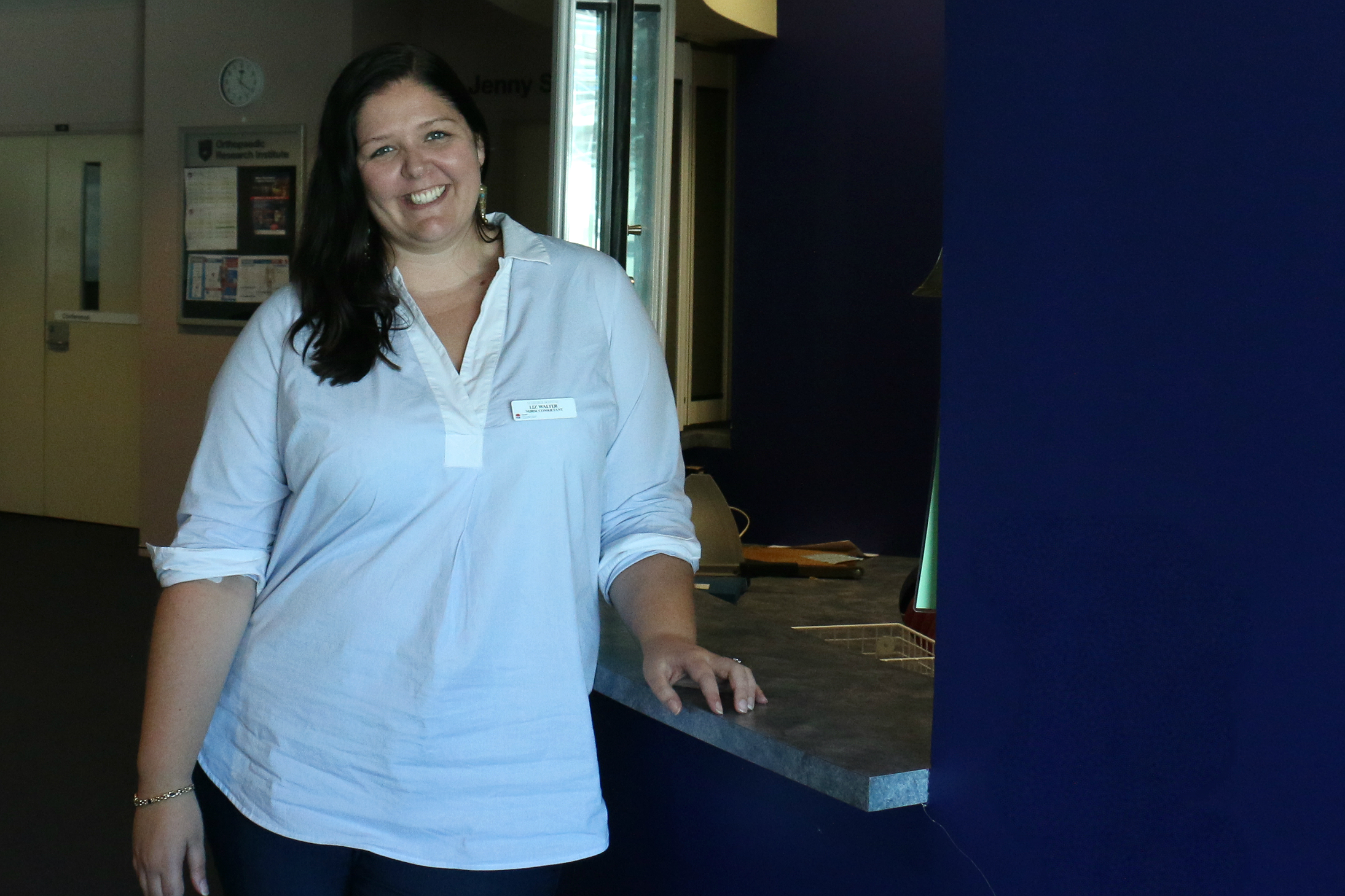 Nurse leaning on reception desk