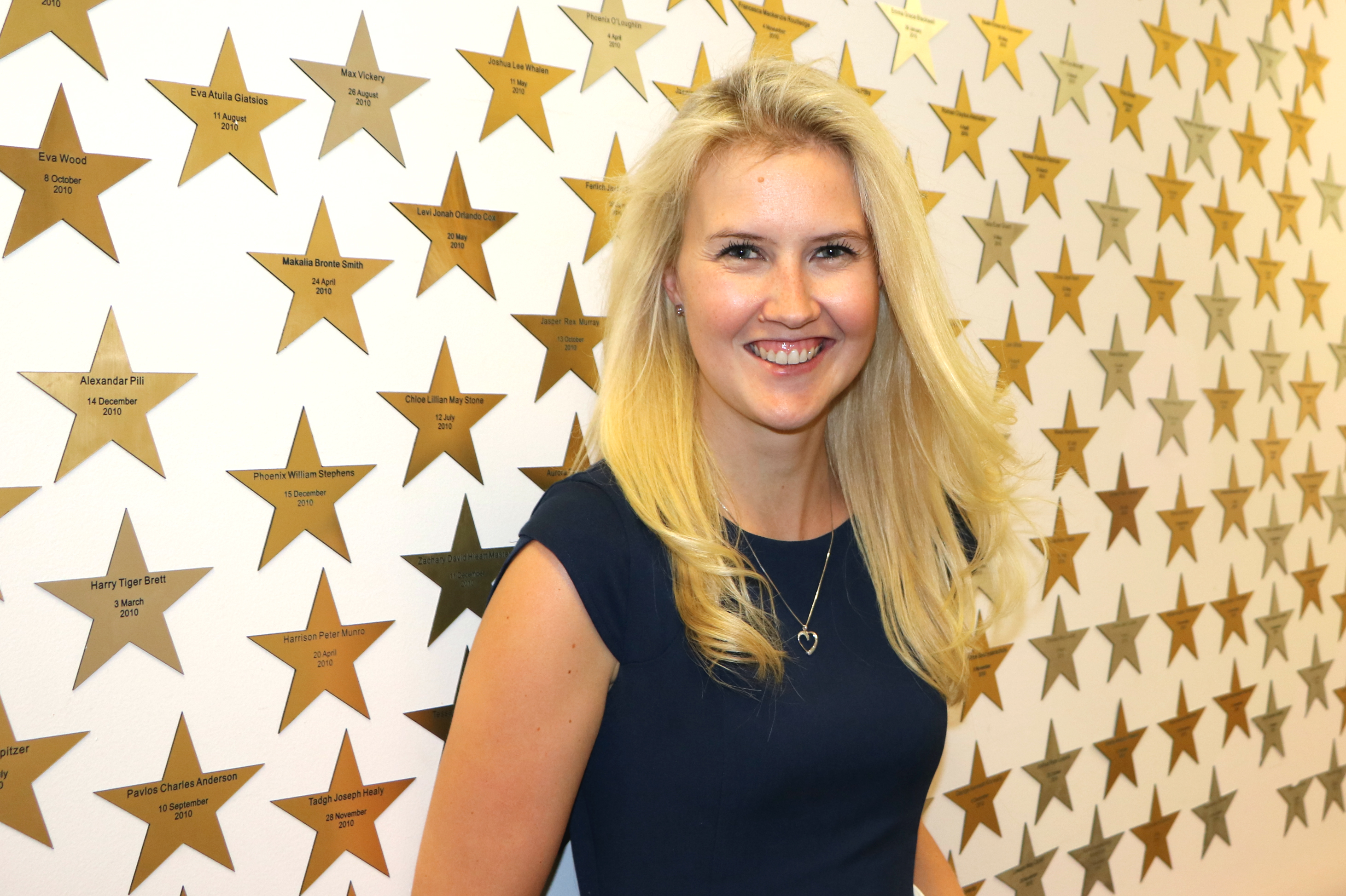 Woman in front of wall with stars on it