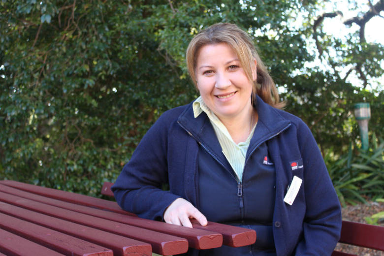 Woman sitting in outdoors leaning on table