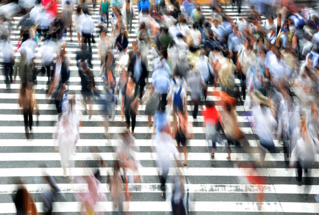 People walking across street crossing. Provides general advice and information on adult and childhood immunisation to healthcare providers, excluding travel vaccination