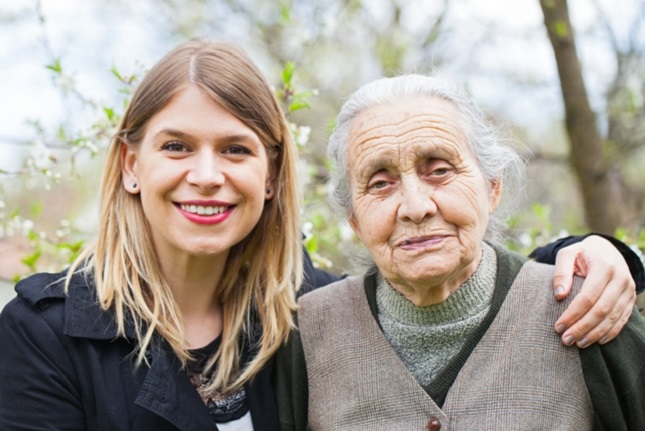 A young woman with her arm around an older woman