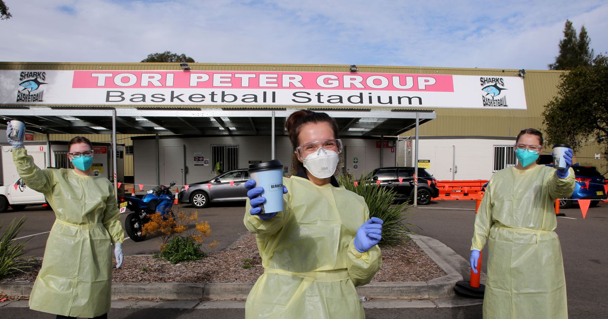 Staff in PPE holding coffees