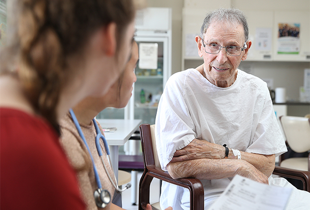 Older gentleman talking to clinicians