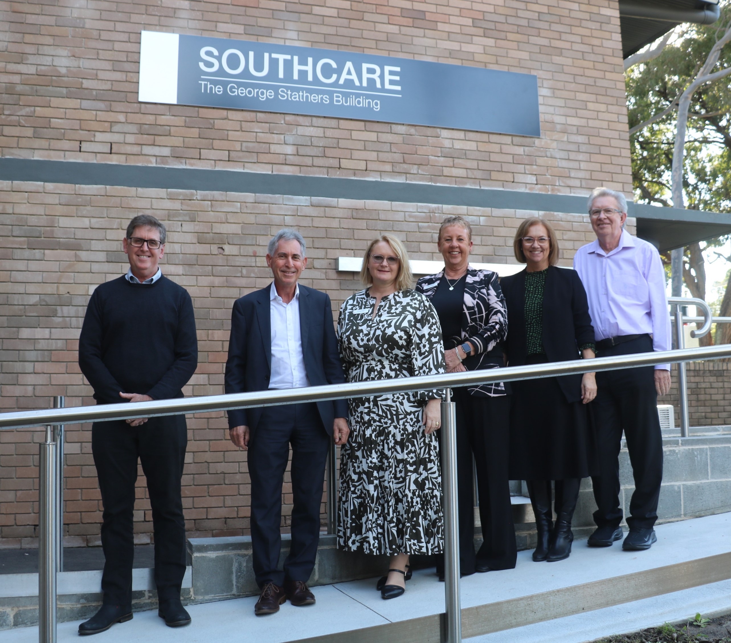 Executive and staff outside Southcare building