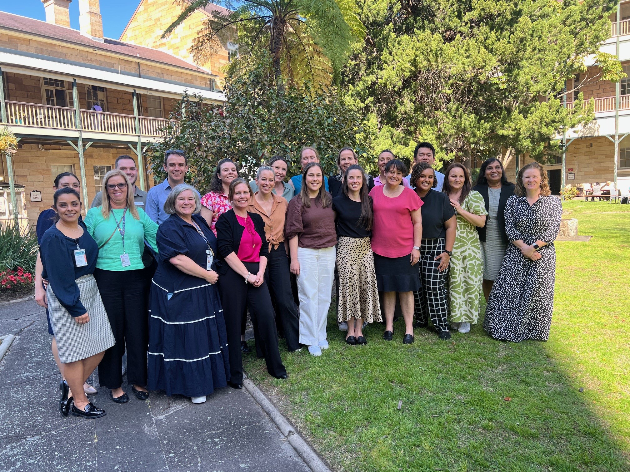 Large group of health professionals in garden setting