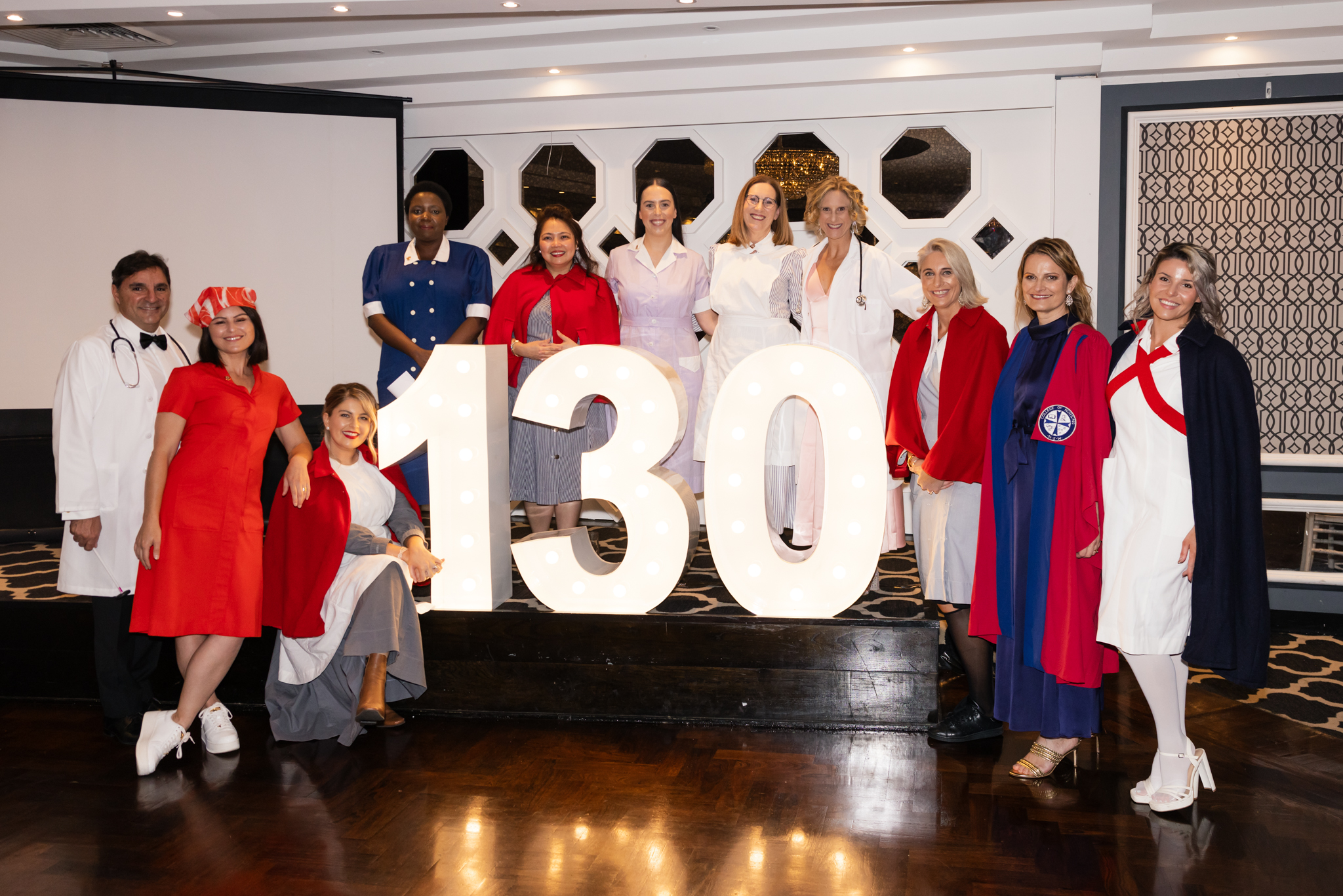 Ushers dress in historic uniforms at hospital ball.